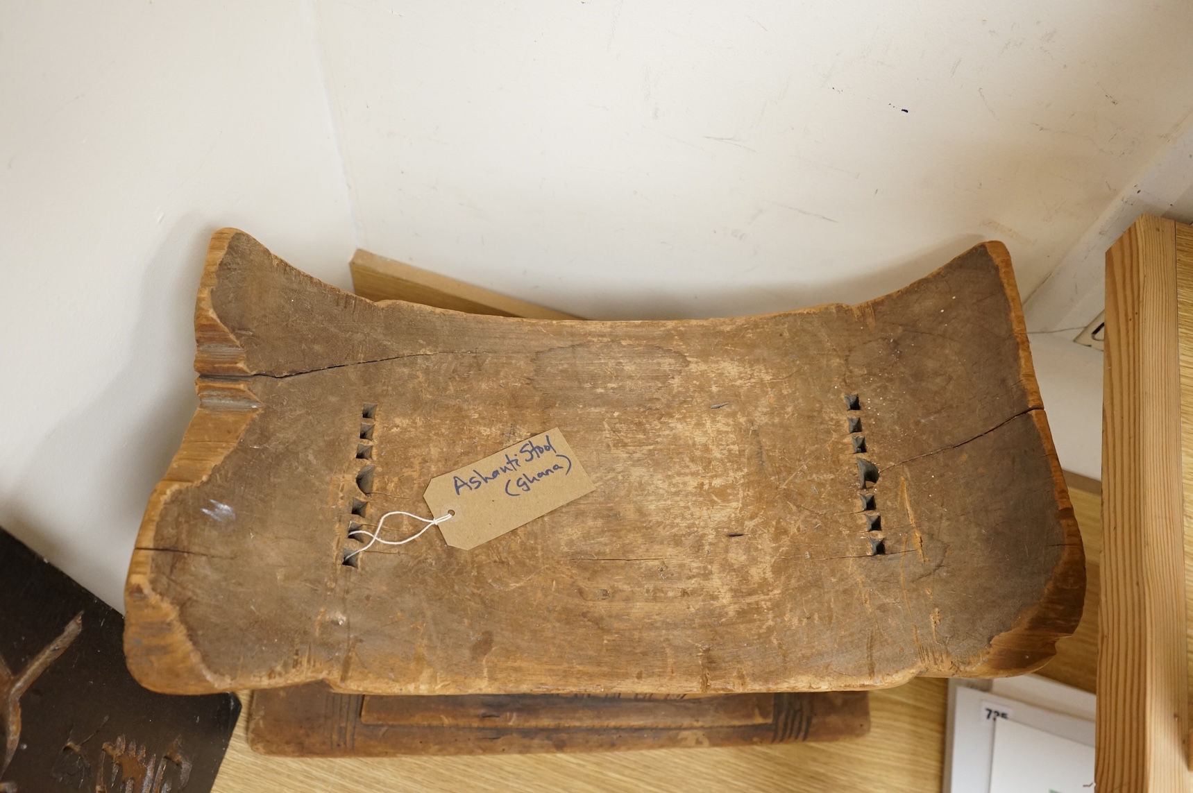 An Ashanti carved wood stool together with a similar headrest, tallest 41cm
